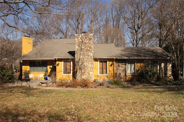 single story home featuring a front yard and a chimney