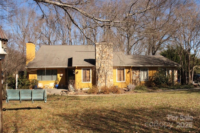 ranch-style house with a patio area, a chimney, and a front yard