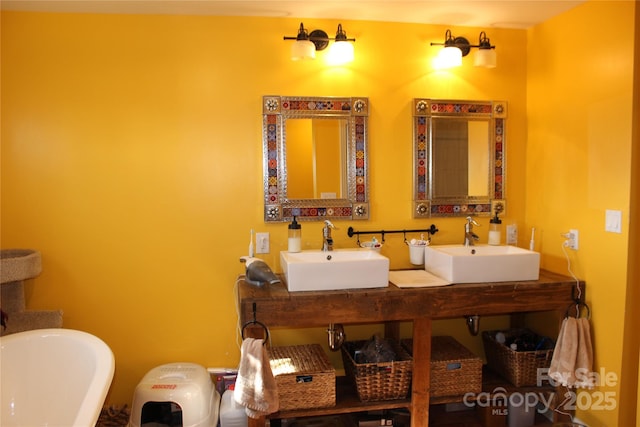 bathroom featuring double vanity, a soaking tub, and a sink