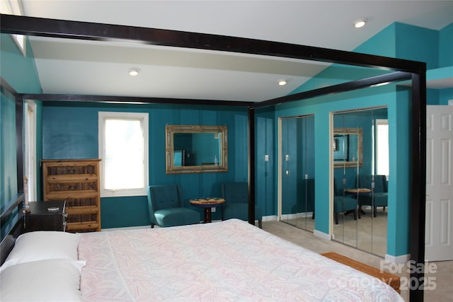 bedroom featuring lofted ceiling with beams, multiple closets, and recessed lighting