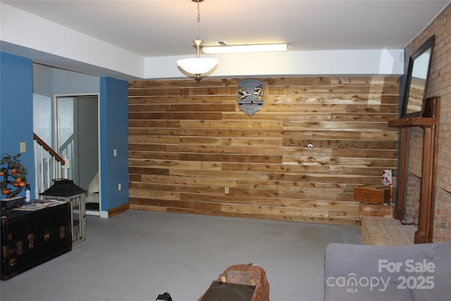 living room featuring finished concrete floors and stairway