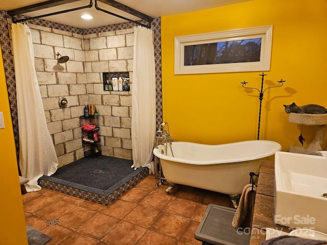 full bathroom with a shower with curtain, a soaking tub, and a sink