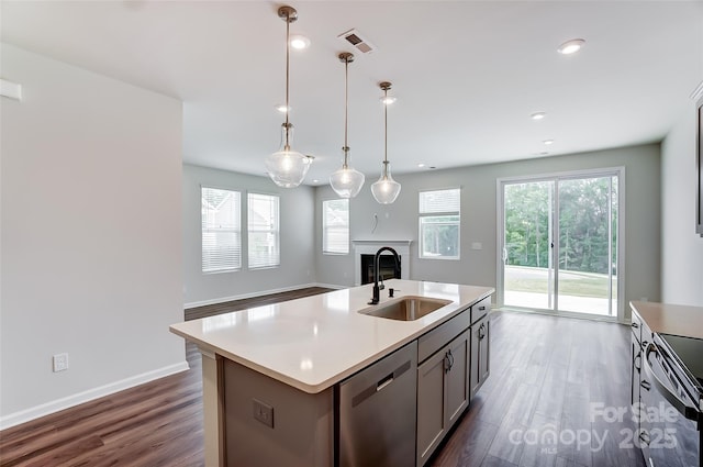 kitchen with sink, dark wood-type flooring, dishwasher, a center island with sink, and decorative light fixtures