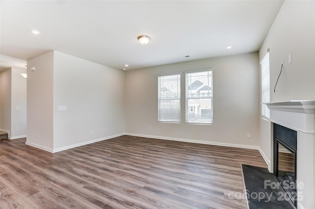 unfurnished living room with hardwood / wood-style floors