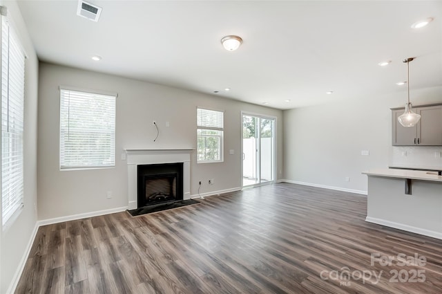 unfurnished living room with dark wood-type flooring