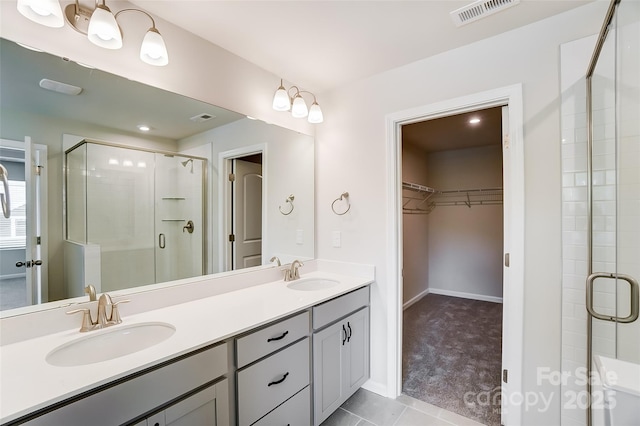 bathroom with vanity, tile patterned flooring, and walk in shower