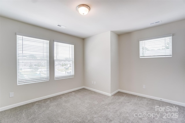 unfurnished room with light colored carpet