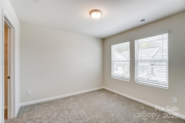 spare room with light colored carpet