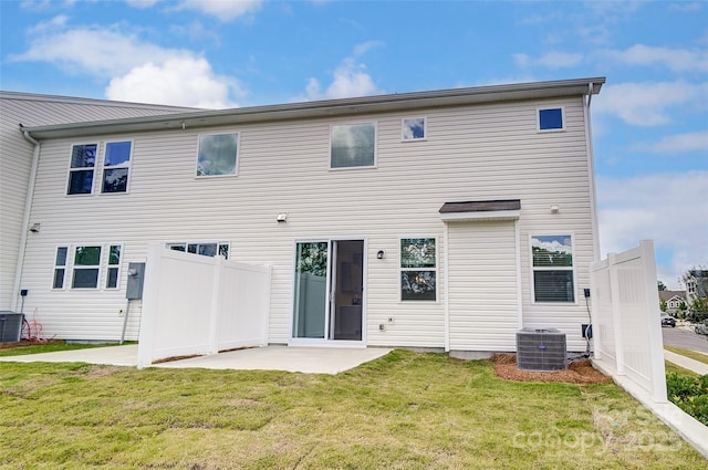 rear view of property with a yard, cooling unit, and a patio area