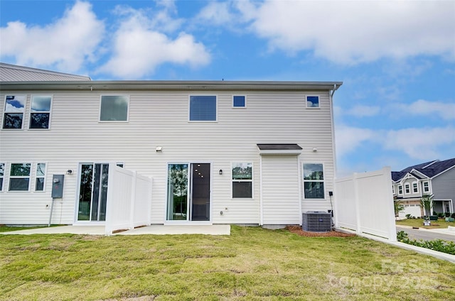 back of property featuring a yard, central AC unit, and a patio area