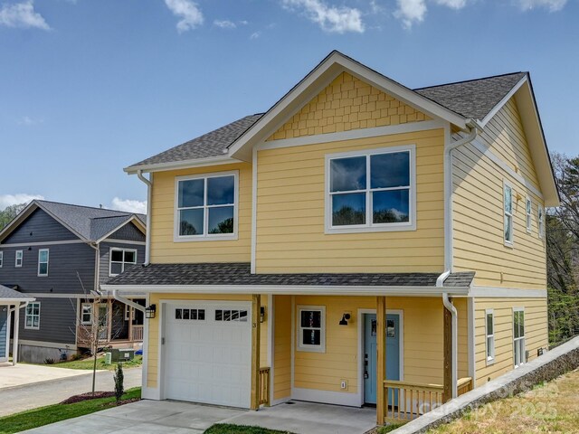 view of front of home featuring concrete driveway, roof with shingles, and a garage