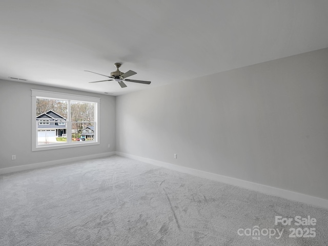 unfurnished room with ceiling fan, baseboards, and carpet floors