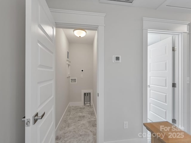 laundry room with laundry area, hookup for a washing machine, electric dryer hookup, visible vents, and baseboards