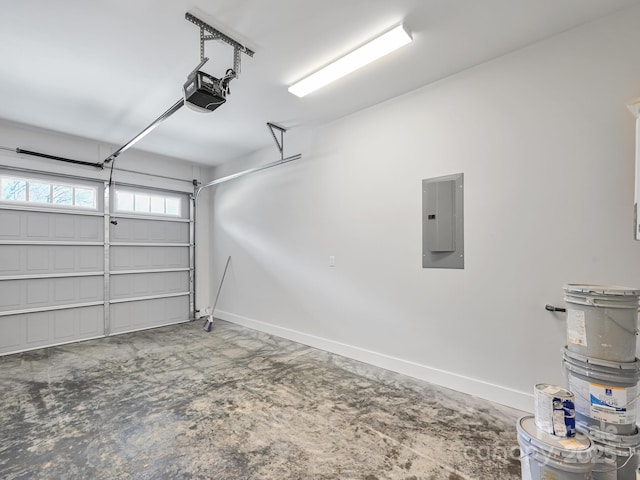 garage with electric panel, baseboards, and a garage door opener