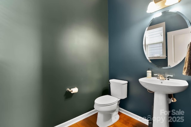 bathroom with sink, toilet, and hardwood / wood-style floors