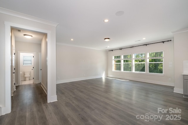 spare room with crown molding and dark hardwood / wood-style floors