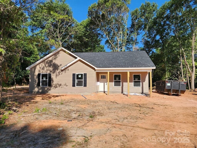 single story home with a shingled roof