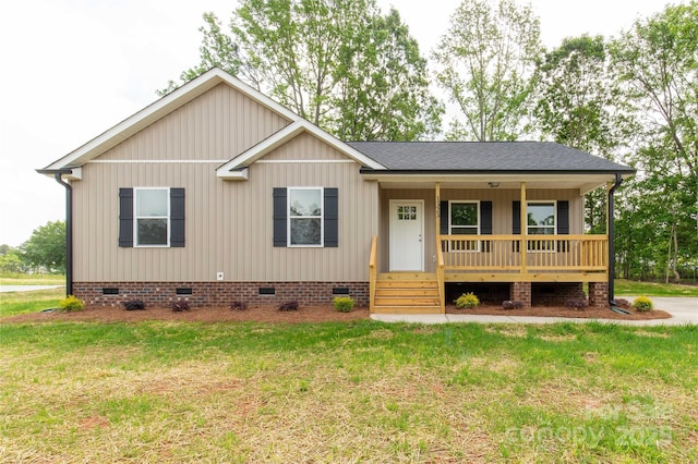 single story home featuring a porch, a shingled roof, a front yard, and crawl space