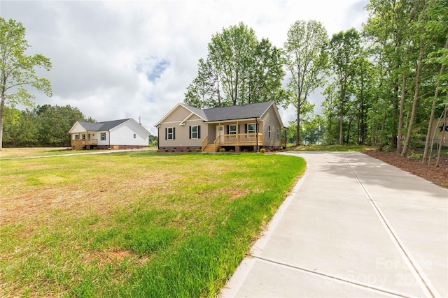 single story home featuring concrete driveway, a front yard, and crawl space