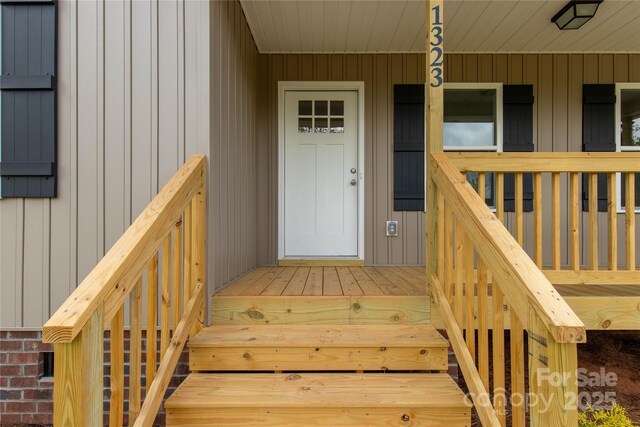 doorway to property featuring a porch and board and batten siding