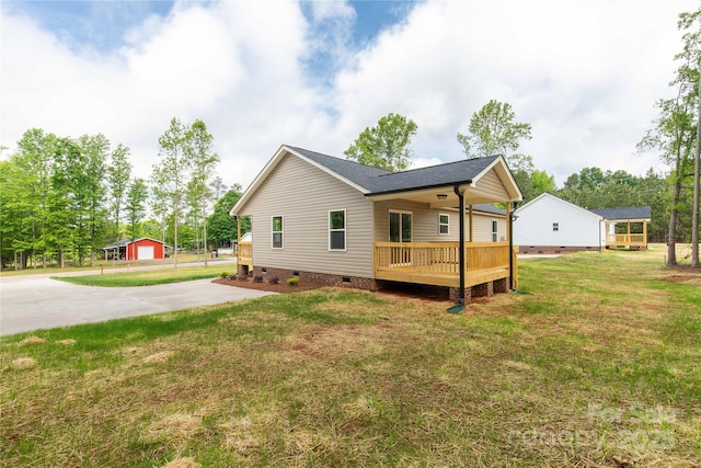 view of home's exterior with a wooden deck, crawl space, a yard, roof with shingles, and concrete driveway