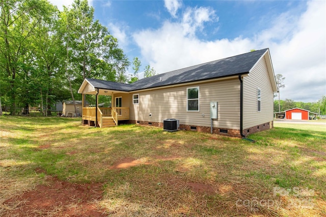 rear view of property featuring central AC unit, a yard, crawl space, and a wooden deck