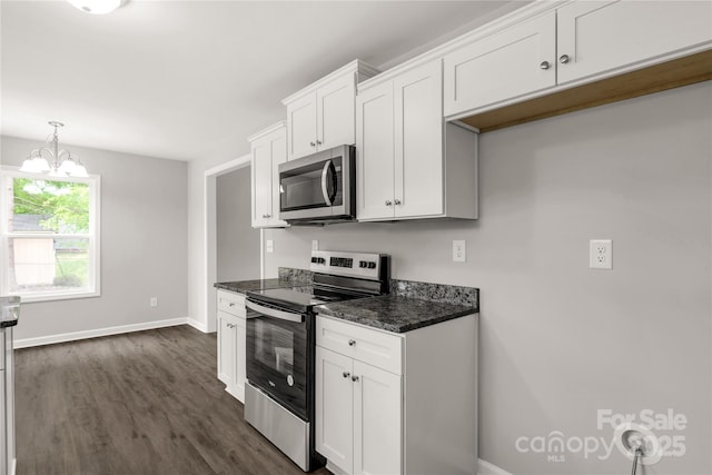kitchen featuring white cabinetry, dark wood-style flooring, appliances with stainless steel finishes, and baseboards