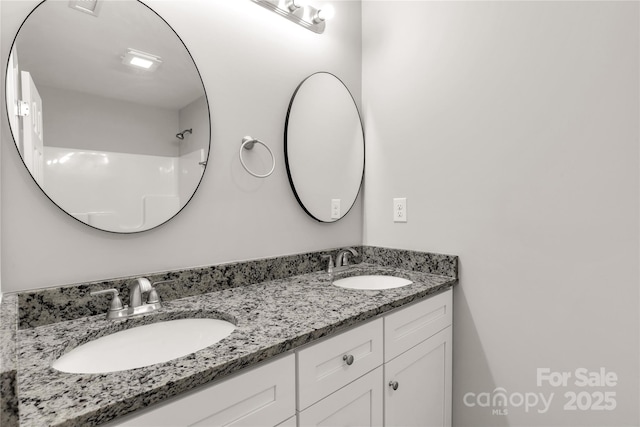 full bath with double vanity and a sink