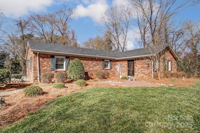 ranch-style home with a front lawn