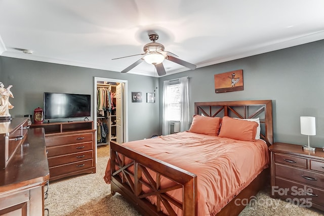 carpeted bedroom with a walk in closet, a closet, and ceiling fan