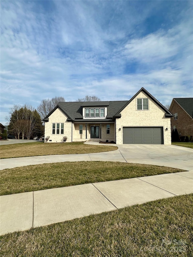 view of front of house with a garage and a front lawn