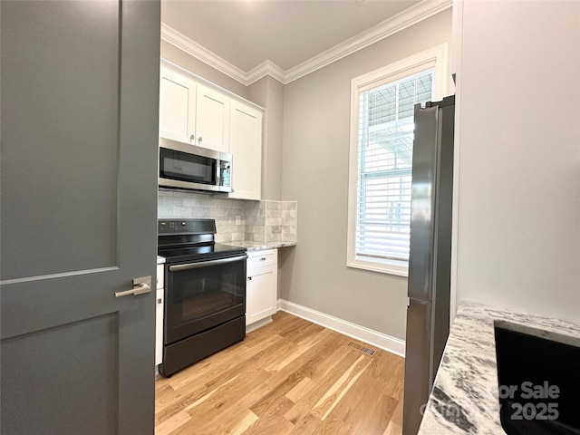 kitchen featuring light stone counters, crown molding, appliances with stainless steel finishes, decorative backsplash, and white cabinets