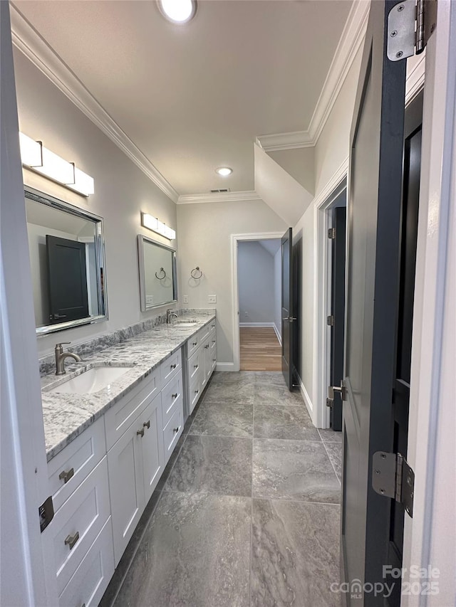 bathroom featuring ornamental molding and vanity