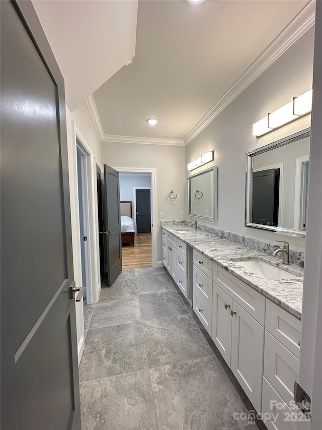 bathroom with crown molding and vanity