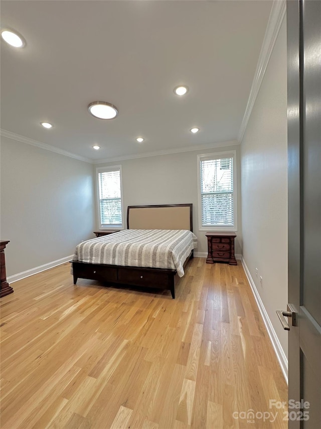 bedroom featuring ornamental molding and light hardwood / wood-style floors