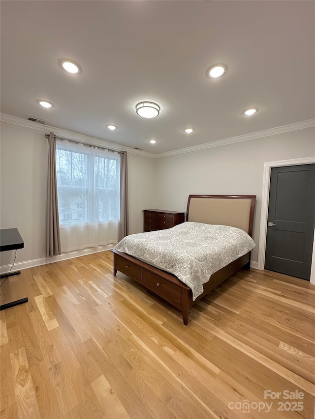 bedroom with crown molding and light wood-type flooring