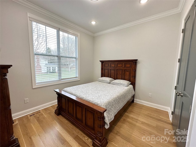 bedroom featuring ornamental molding and light hardwood / wood-style floors