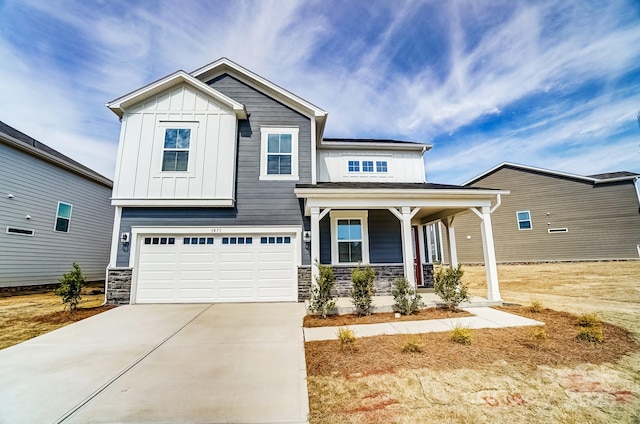 craftsman inspired home featuring a porch, an attached garage, concrete driveway, stone siding, and board and batten siding