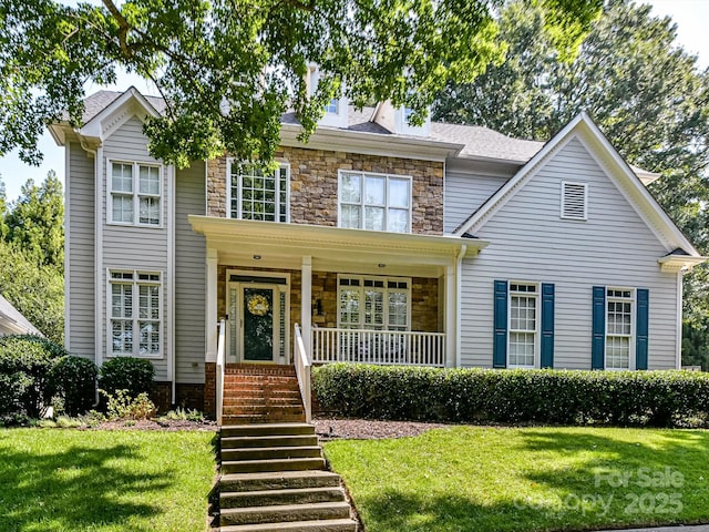 view of front of property with a porch and a front lawn