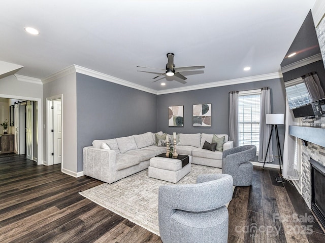 living room with a fireplace, dark wood-type flooring, ornamental molding, and ceiling fan