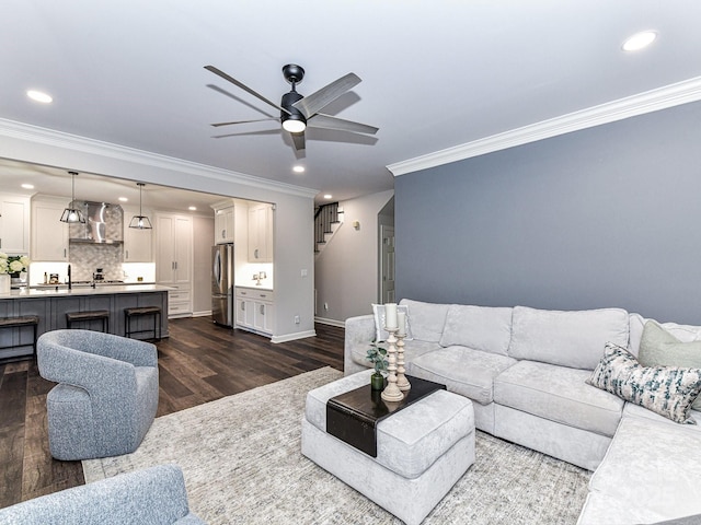 living room with ceiling fan, ornamental molding, and dark hardwood / wood-style flooring