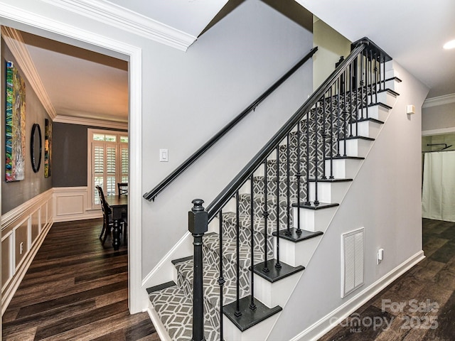 stairway featuring hardwood / wood-style flooring and ornamental molding