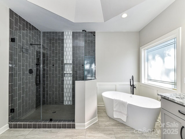 bathroom with vanity and independent shower and bath