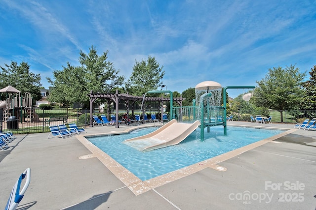 view of swimming pool featuring a playground and pool water feature