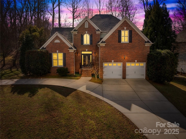 traditional home with a garage, concrete driveway, and brick siding