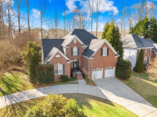 traditional-style home featuring a garage, brick siding, driveway, crawl space, and a front yard