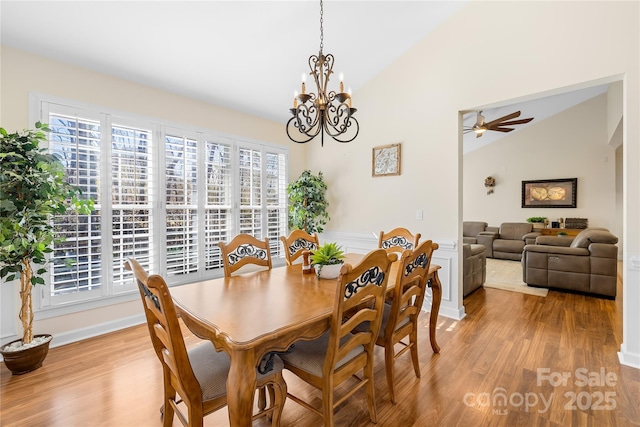 dining space with light wood-style floors, lofted ceiling, and a healthy amount of sunlight