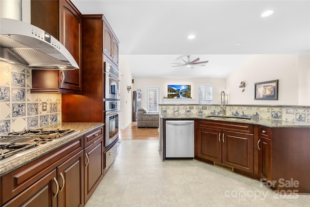 kitchen with stainless steel appliances, a sink, ventilation hood, light stone countertops, and tasteful backsplash