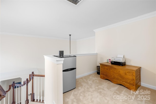 office space with ornamental molding, light colored carpet, visible vents, and baseboards