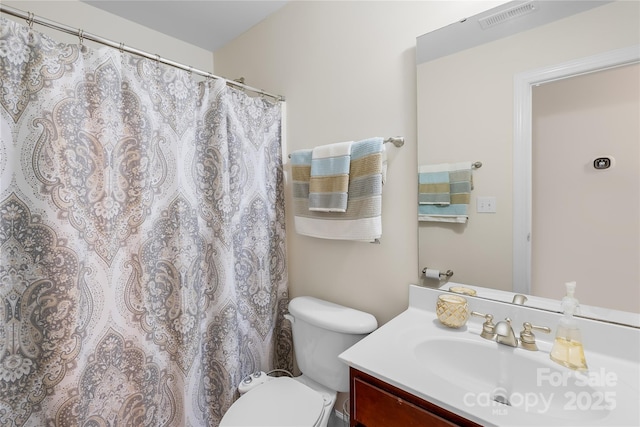 full bath with toilet, vanity, and visible vents